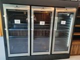 three refrigerators that are on display in a store