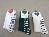 three pairs of socks with dots on them sitting on a table