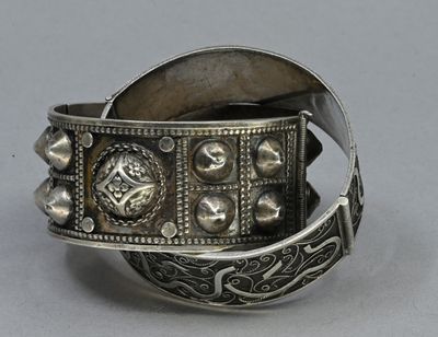 an old silver bracelet with a cross and a cross on it