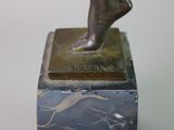 statue of a woman standing on top of a marble block