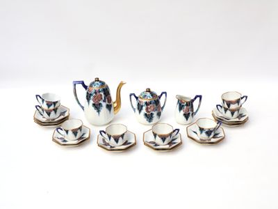 nine cups and a teapot sitting on a table