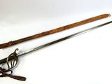 an old pair of swords with a wooden handle on a white surface