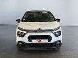 the front view of a white citrole parked in a room
