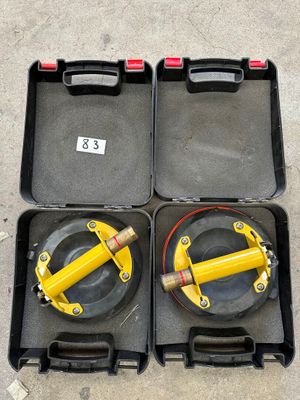 two yellow cylinders in a black case on the ground