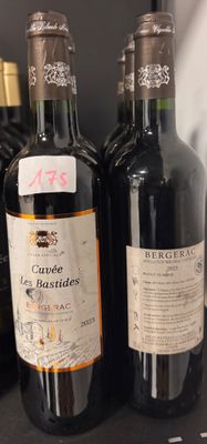 several bottles of wine are lined up on a shelf in a store