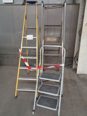two ladders that are next to each other in a garage