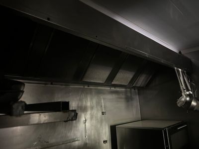a kitchen with a stove and a microwave in it