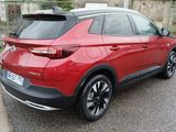 a red car that is parked on the side of the road