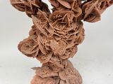 a sculpture of a vase made out of paper flowers
