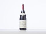 the bottle of red wine is sitting on the table