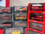 a lot of red and yellow toy cars in the boxes