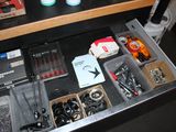a drawer full of assorted items on a desk