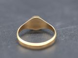 a close up of a gold ring on a black surface