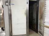 a door in the middle of a dirty kitchen