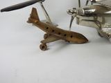 a silver model of an airplane next to a silver model of a plane