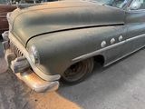 an old car that is sitting in the parking lot
