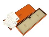 an orange box with a pair of earrings in it