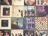 a lot of different album covers on the wall