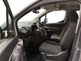 the interior of a car with the door open and the driver ' s seat down