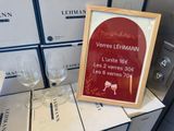 a picture of wine glasses and a framed sign on a table
