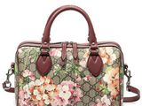 a brown and pink floral bag on a white background