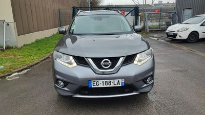the front of a silver nissan suv parked on the side of a road