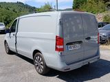 a silver van that is parked in a parking lot