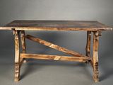 an old wooden table sitting on top of a gray floor