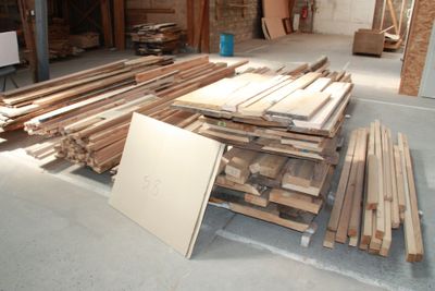 many pieces of wood stacked on the floor in a room
