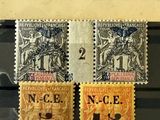 three different stamps are displayed in a display case on a table