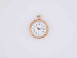 a small gold pocket watch with roman numerals on the face
