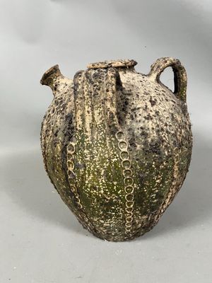 a vase that is sitting on a white surface
