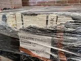 a mattress that is wrapped in plastic and sitting on a pallet