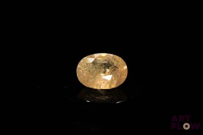 a yellow diamond on a black surface