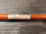a close up of a pen on a wooden table
