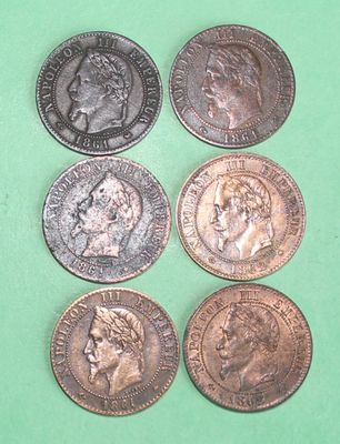 four different types of coins are shown on a green surface