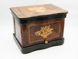 a small wooden box with a bird and flowers on it
