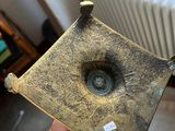 a man holding a piece of metal with a hole in it