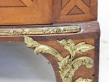 a wooden cabinet with a gold decoration on it