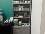 a small kitchen with a black refrigerator and a black refrigerator freezer