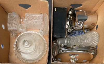 two boxes with glass items inside of them on a table