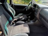 the interior of a car with the door open showing the front seats