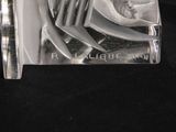 a glass sculpture of a man holding a knife and fork