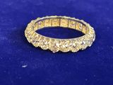 a close up of a gold ring on a blue surface