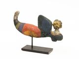 an image of a sculpture of a dog on a wooden base