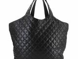 a black quilted tote bag on a white background