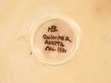 a close up of a white vase with writing on it