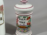 two salt and pepper shakers sitting next to each other