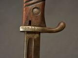 a close up of a knife on a stand