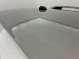 a white sink with a black faucet in it